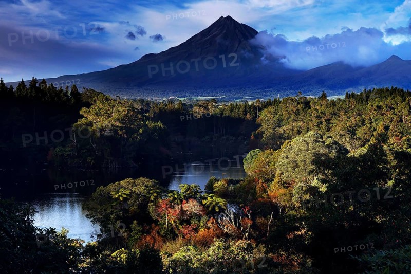 Mount Taranaki above Lake Mangamahoe, surrounded by lush green nature, New Zealand, zero