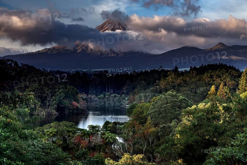 Lake Mangamahoe with Mount Taranaki in the background, surrounded by wooded landscape, New Zealand, zero