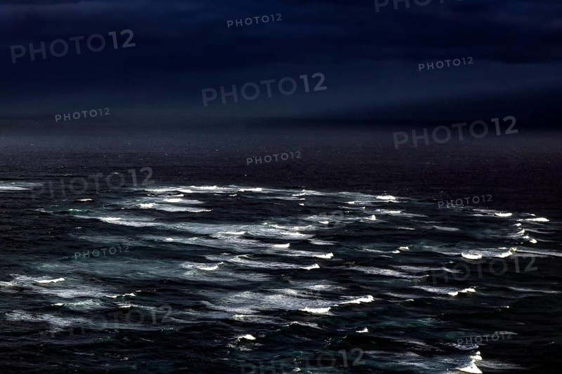 Gloomy image of the confluence of the Tasman Sea and Pacific with surging waves, Cape Reinga, Northland, New Zealand