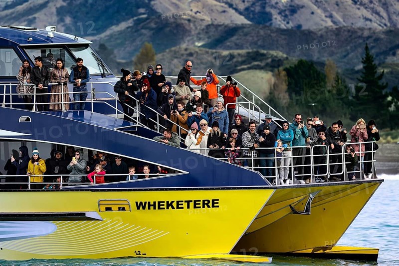 Tourists watch marine life off Kaikoura, Kaikoura, New Zealand on a boat