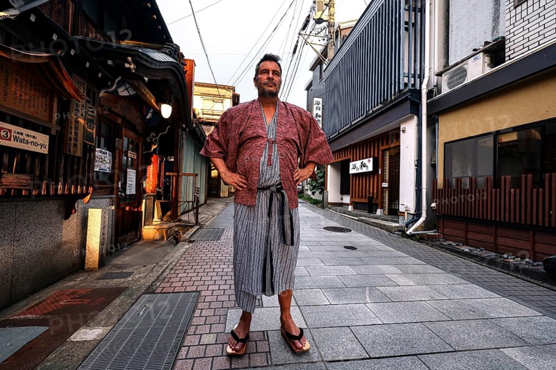 Man in yukata posing on a quiet street in Yamanouchi, Yamanouchi, Japan