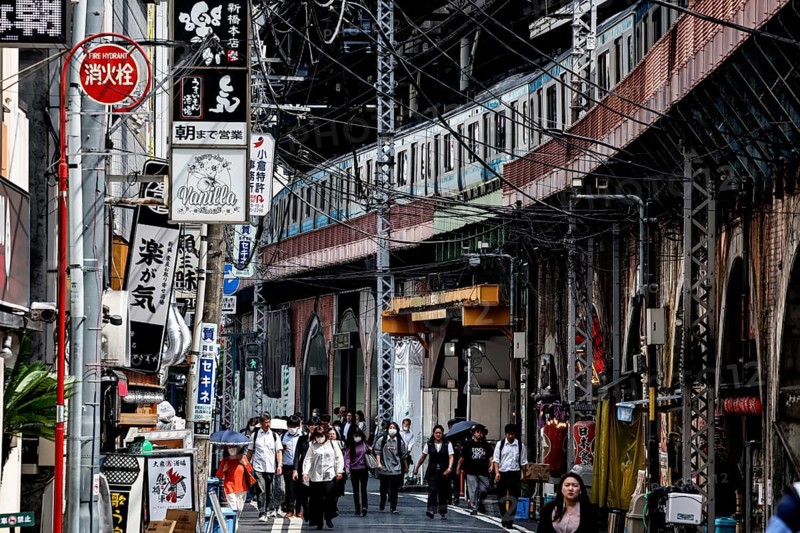 Bustling street scene in Chuo with numerous people and shops, Tokyo, Japan
