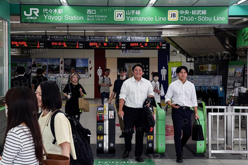 Entrance of a busy train station with commuters in Tokyo, Tokyo, Japan