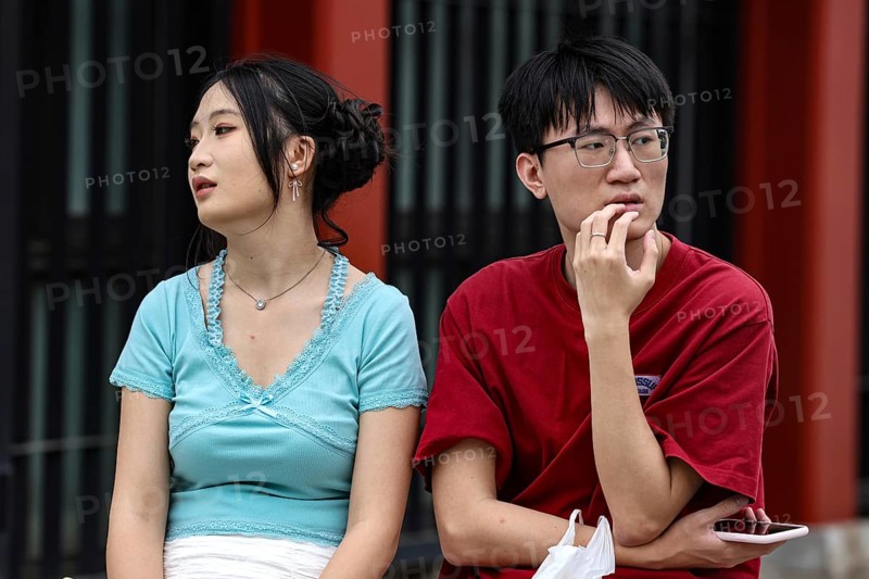 A couple sits thoughtfully on a bench in Asakusa, Tokyo, Tokyo, Asakusa, Japan
