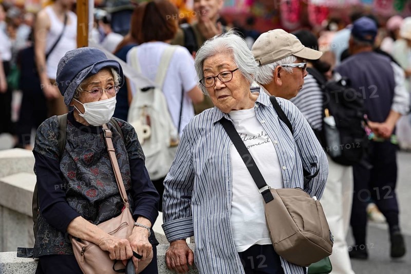 Two elderly woman talking on a busy street in Asakusa, Tokyo, Tokyo, Asakusa, Japan