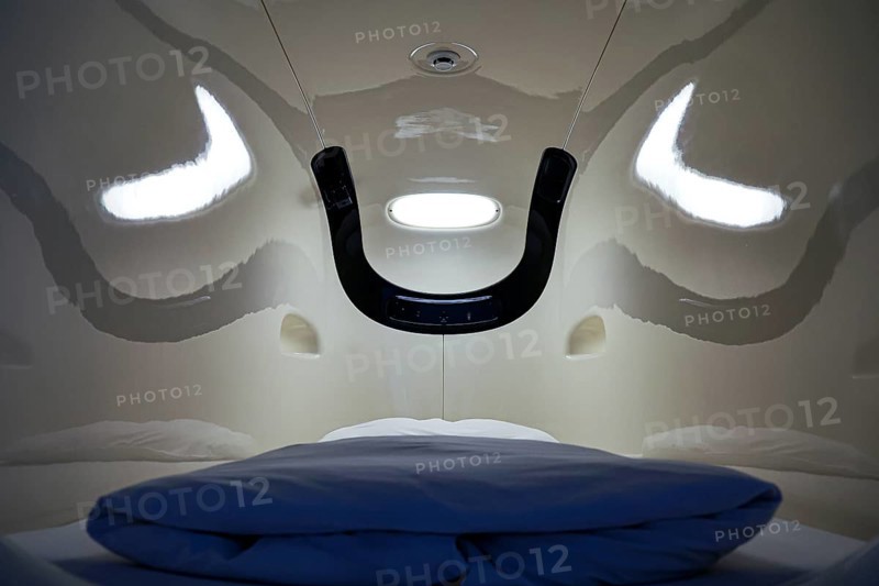 Interior of a capsule hotel sleeping capsule, futuristic design with blue pillow, Tokyo, zero, Japan