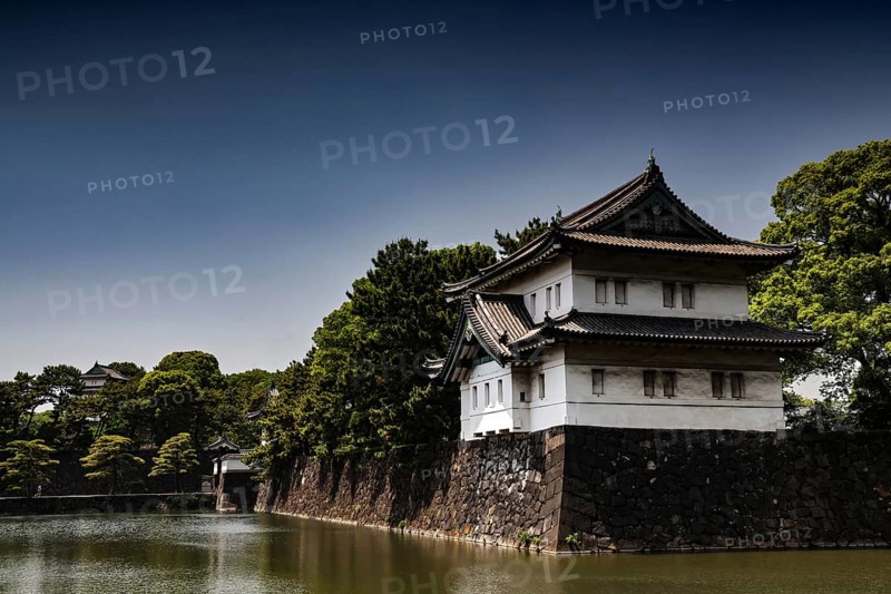 Imperial Palace wall with adjacent moat in peaceful surroundings, Tokyo, Japan