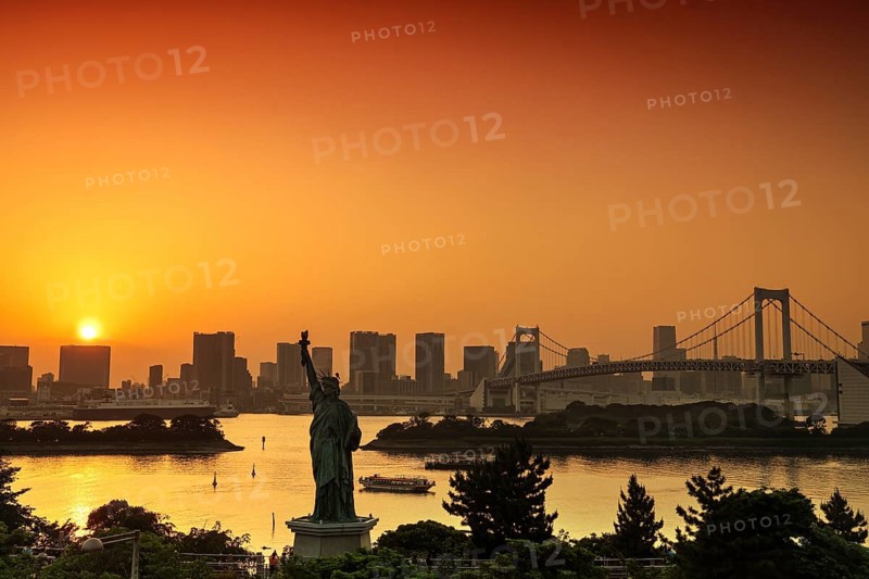 Statue of Liberty and Rainbow Bridge in the background of a sunset, Tokyo, Japan