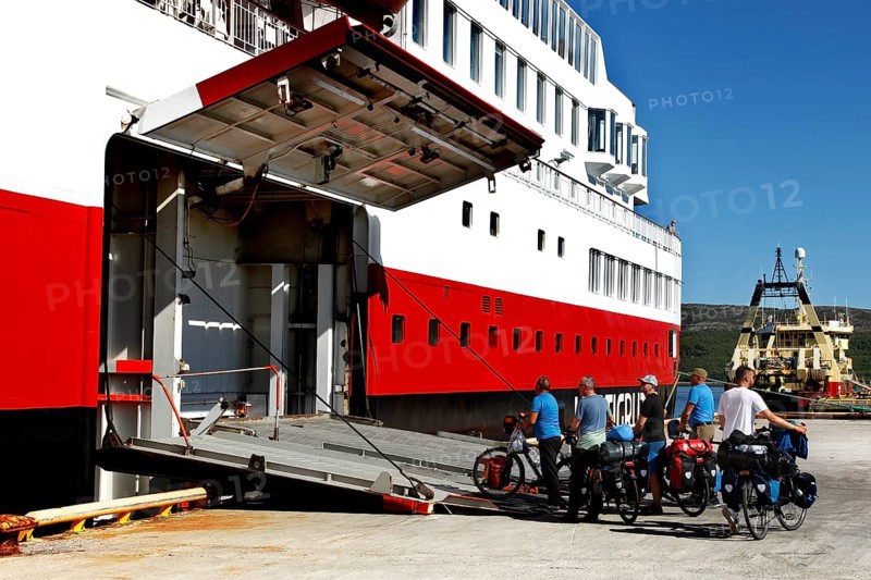 Cyclists enter the Hurtigruten ship via the tailgate in Kirkenes, Kirkenes, Finnmark, Norway