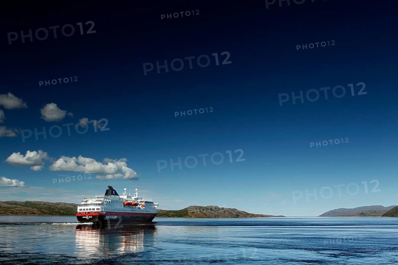 Hurtigruten ship on calm sea with bright sky, Kirkenes, Finnmark, Norway