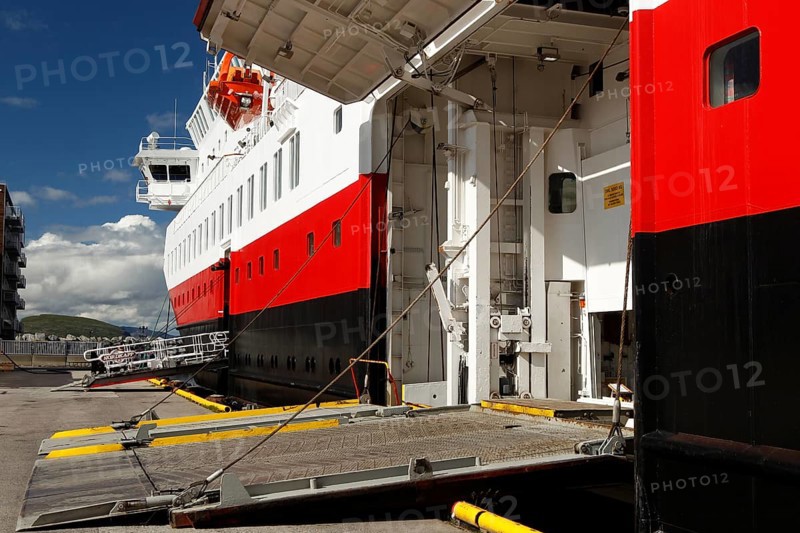 Hurtigruten ship on the quay with open cargo hatch under bright blue sky, Hammerfest, Finnmark, Norway