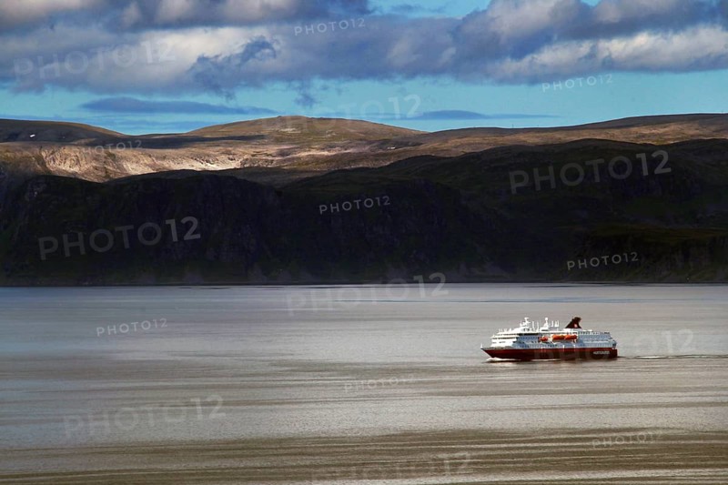 Hurtigruten ship off the coast at Hammerfest, calm seas under cloudy sky, Hammerfest, Finnmark, Norway