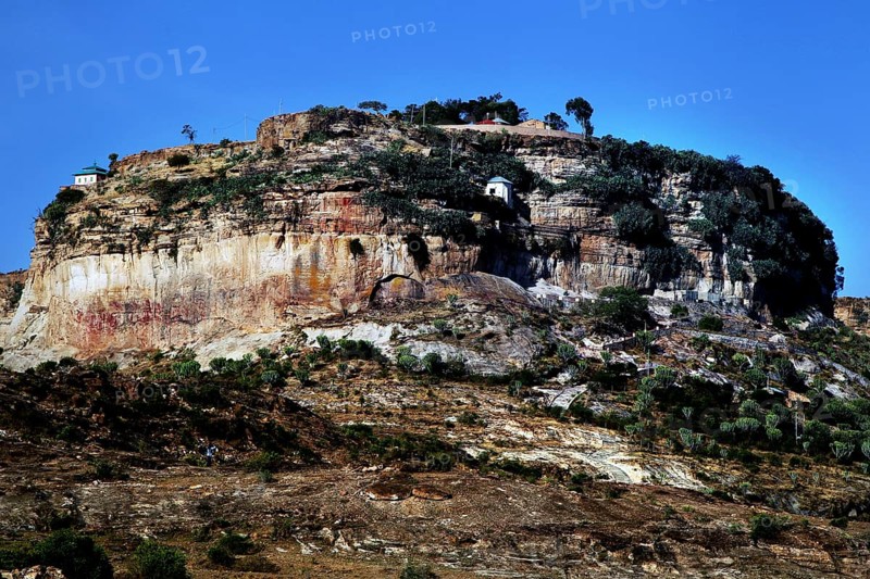 A monastery perched on a wooded plateau under clear skies, Debre Damo, Tigray, Ethiopia