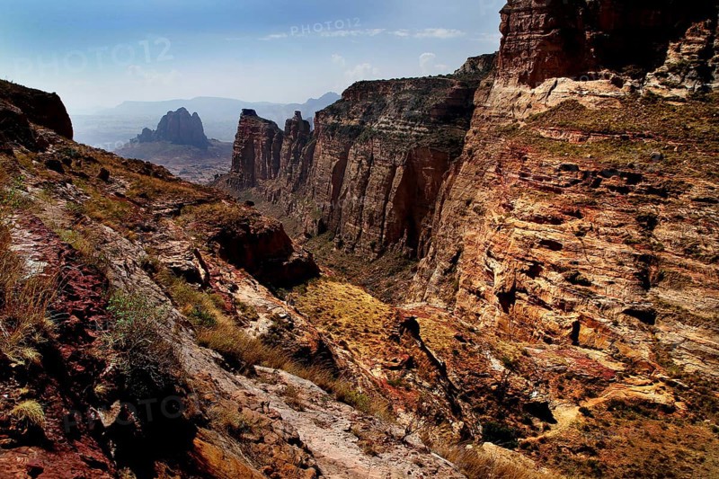 Dramatic rock formations in the arid Gheralta Mountains with sparse vegetation