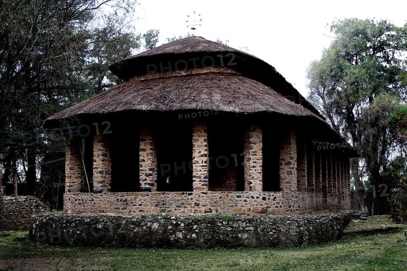 Stone church with round roof and columns in Debre Berhan Selassie