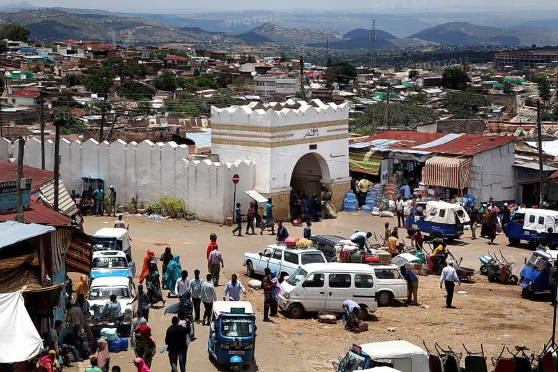 The Shoa Ber West Gate of Harar surrounded by busy markets and vehicles, Harar, Harari, Ethiopia