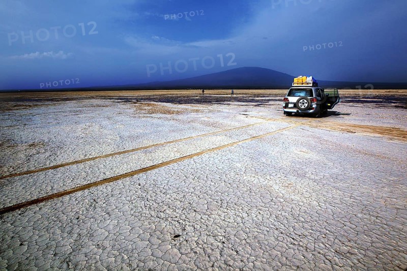 Land cruiser in a barren desert landscape with mountain views, Kusrawad, Ethiopia