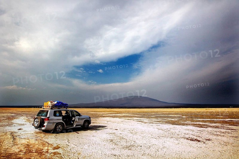 Landcruiser stands in a vast landscape with dramatic skies, zero