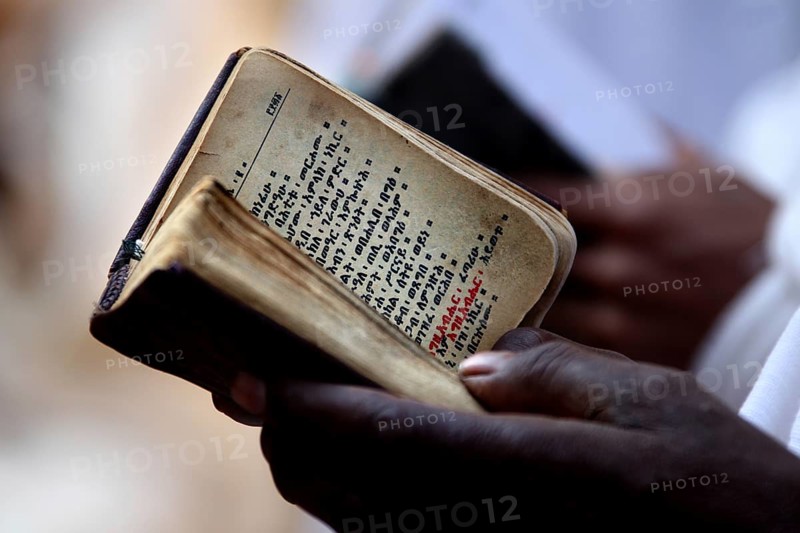 Close-up of a Bible in hands, symbolic religious practice in Lalibela, Lalibela, Amhara, Ethiopia
