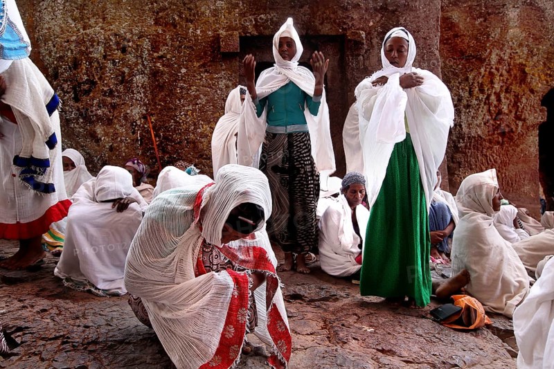 Women wearing white robes pray during Easter at Bete Maryam Church, Lalibela, Amhara, Ethiopia