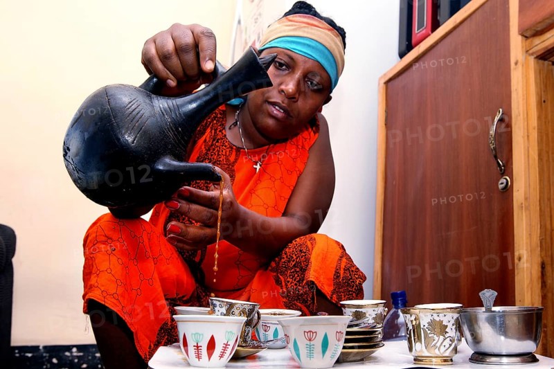 Woman performs traditional coffee ceremony during Easter, Lalibela, Ethiopia