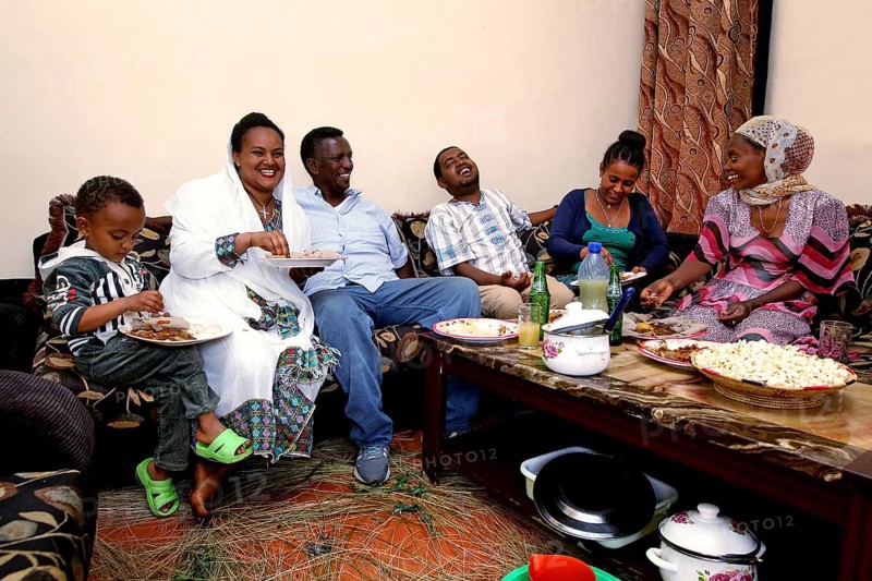 Family enjoying Easter dinner together with traditional elements, Lalibela, Ethiopia