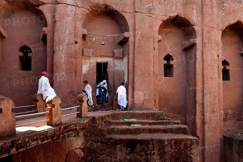 People wearing traditional clothing in the impressive Bete Gabriel Raphael Rock Church, Lalibela, Amhara, Ethiopia