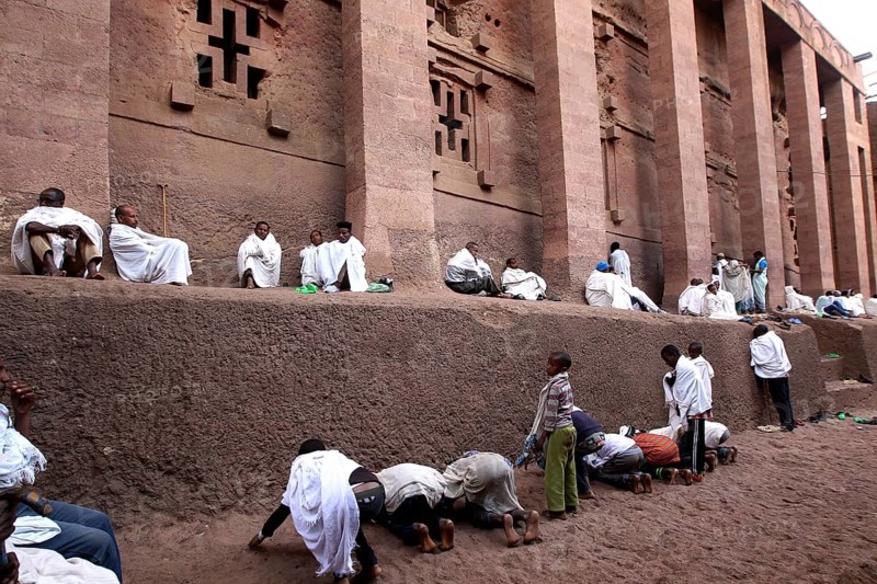 People wearing white robes pray at the Bete Medhane Alem Rock Church during Easter, Lalibela, Amhara, Ethiopia