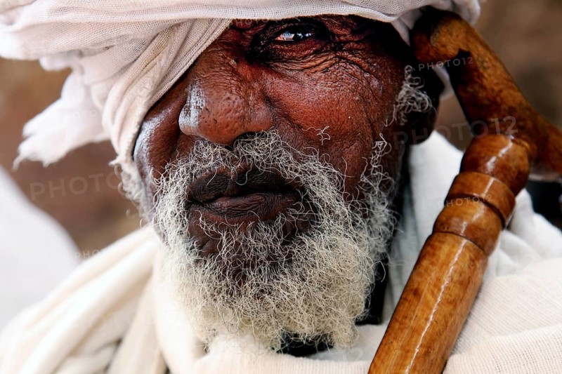 Portrait of an elderly man wearing a turban, deep in thought, Lalibela, Amhara, Ethiopia