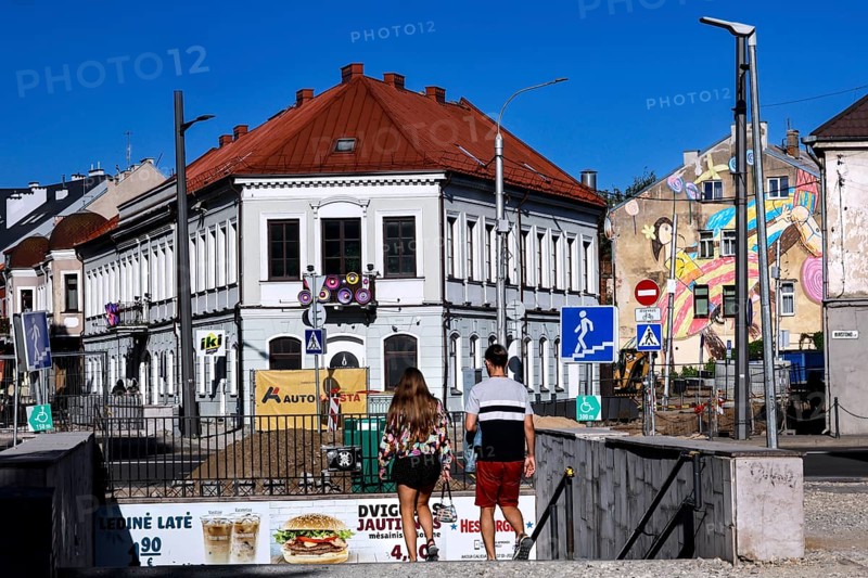 Vilnius Gatve in Kaunas with pedestrians and colorful buildings under blue sky, Kaunas, Kaunas, Lithuania