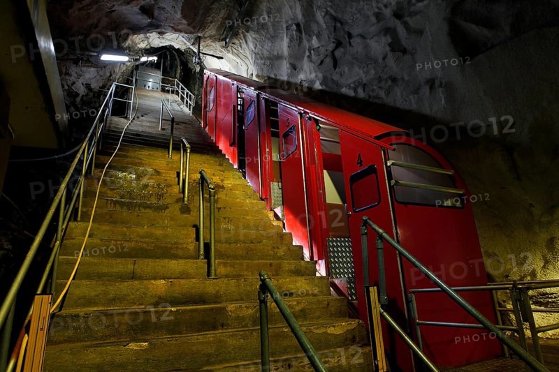 Steep stairs to the entrance to the Gaustabanen cable car, red wagons in a cave, zero