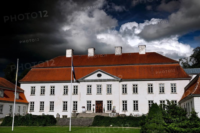 Large historic manor house with dramatic cloudy sky, Suuremäisa, Hiiumaa, Estonia