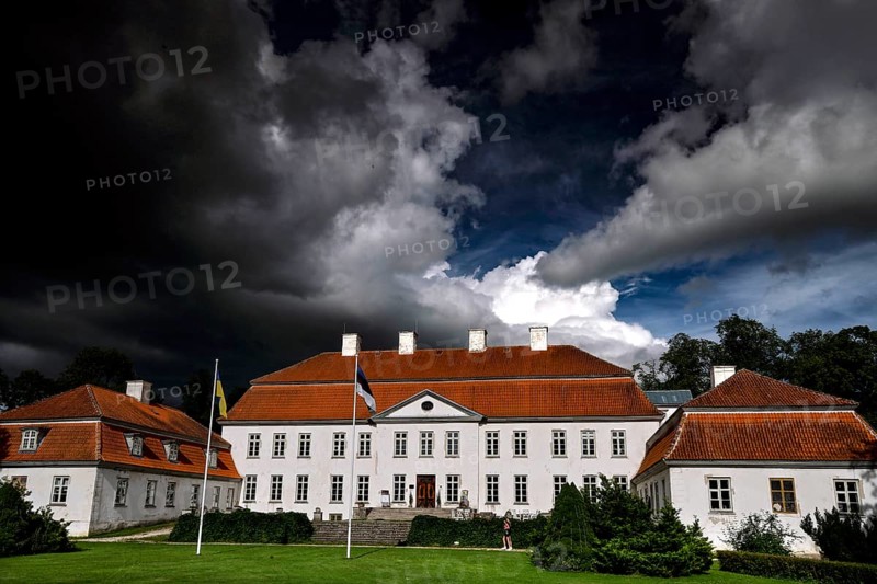 Historic manor house with red roofs under dramatic sky, Suuremäisa, Hiiumaa, Estonia