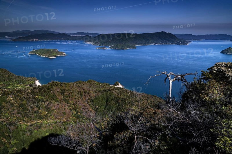 View from Mount Misen of a vast bay with several islands under a blue sky, Miyajima, Hiroshima, Japan