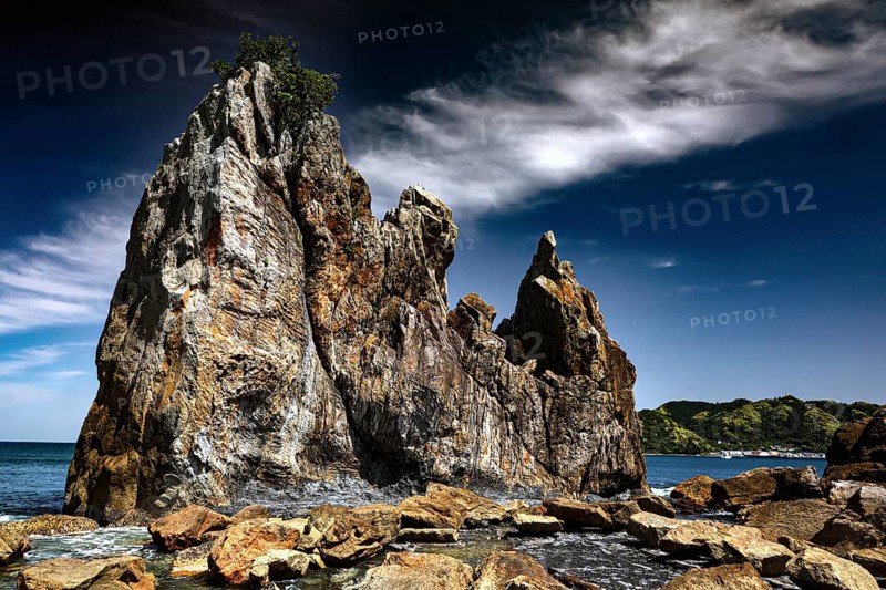 Weather-eroded rocks on the coast under a cloudy sky, Kushimoto, Wakayama, Japan