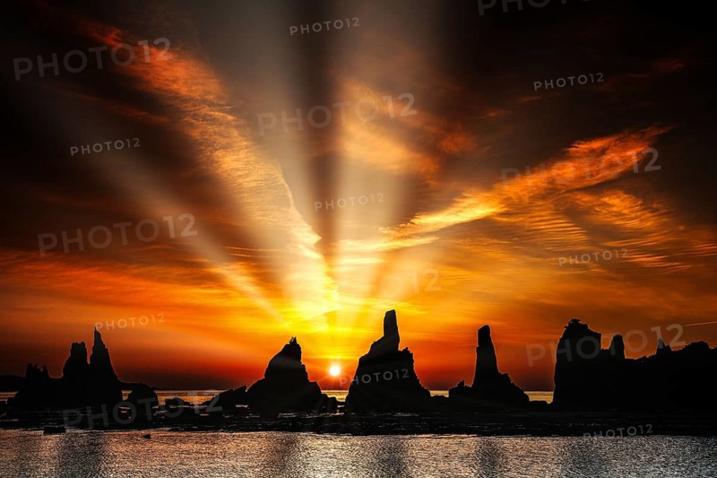 Impressive sunbeams over rock formations at dawn, Kushimoto, Japan