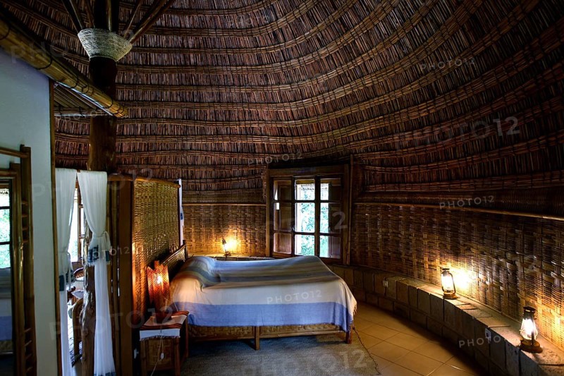 Cozy room at Aregash Lodge with thatched roof and wooden furniture, Yirga Alem, Ethiopia
