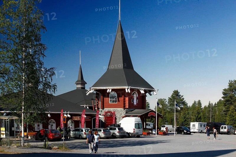 Santa Claus village building with pointed tower and bright red façade, Napapiiri, Finland
