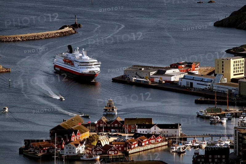 Harbour view of Svolvær with a Hurtigruten ship, surrounded by the picturesque coastal town, Svolvær, Nordland, Norway