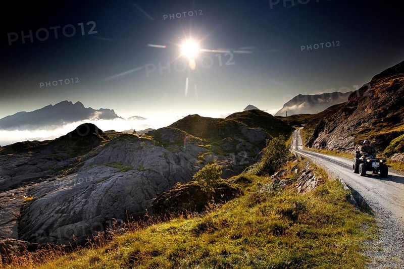 ATV rides through the rolling countryside of Lofoten under dazzling sunlight, Vestvågøy, Neslandsveien, Norway