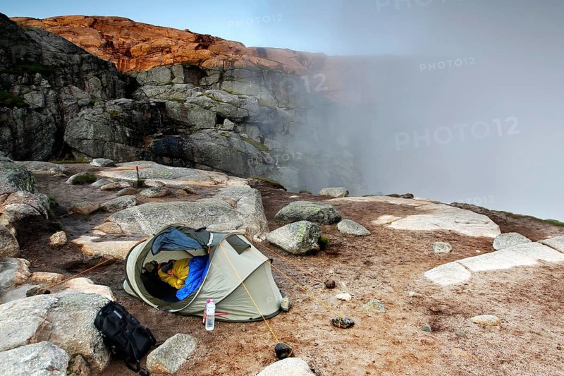 Tent on rocky terrain with fog, near Kjerag, Lysefjord, Rogaland, Norway