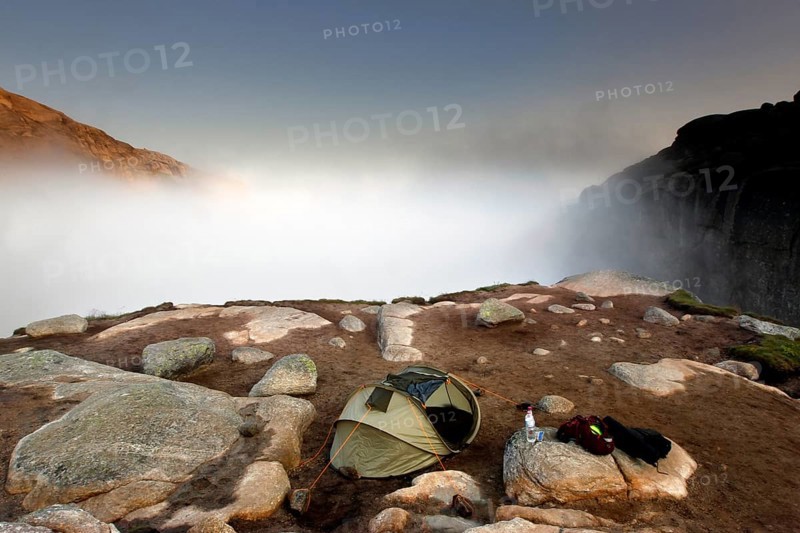 Single tent in fog on a rocky plateau near Kjeragbolten, Lysefjord, Rogaland, Norway