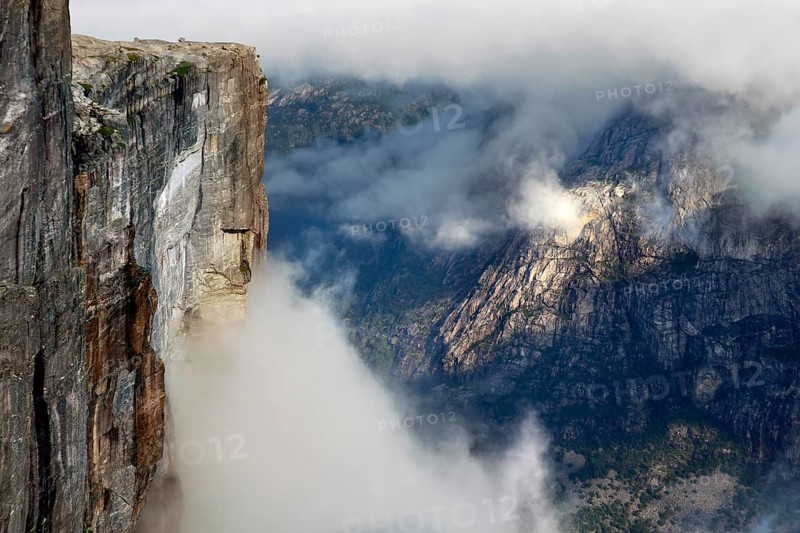 Impressive scene with misty cliffs over Lysefjord, Kjerag, Rogaland, Norway