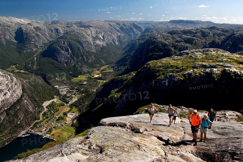 Hikers enjoy spectacular views while climbing Kjerag, Lysefjord, Rogaland, Norway