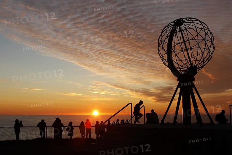 Crowd of people at the North Cape globe at a picturesque sunset, North Cape, Magerøya, Norway
