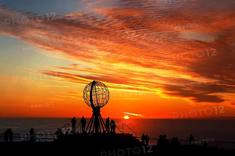 Sunset on the North Cape with colorful clouds and silhouettes in front of the globe, North Cape, Magerøya, Norway