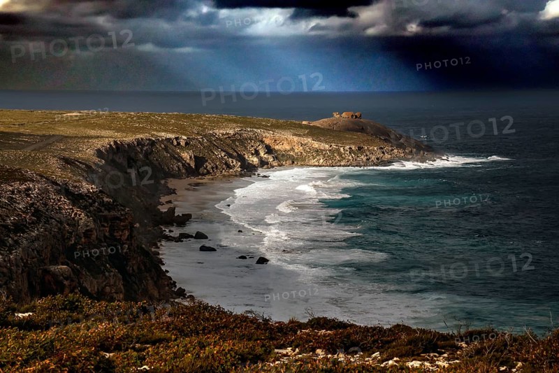 The dramatic coastline of Cape du Couedic with strong swell under dark skies, Kangaroo Island, South Australia, Australia