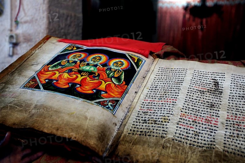 Interior view of the Axumite St. Mary's Cathedral with illustrated Bible showing detailed manuscripts, Axum, Ethiopia