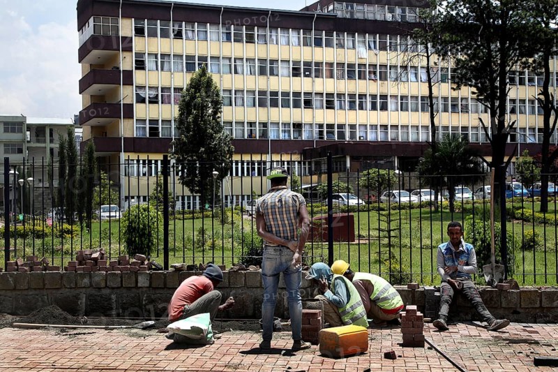 Workers maintaining sidewalks in front of a municipal building, Addis Ababa, Ethiopia