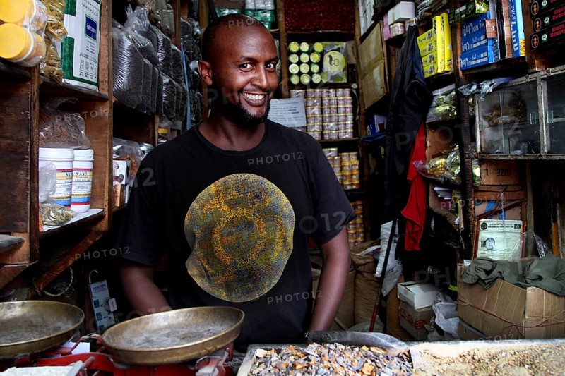 A friendly salesman stands in his shop full of spices in Mercato, Addis Ababa, Ethiopia